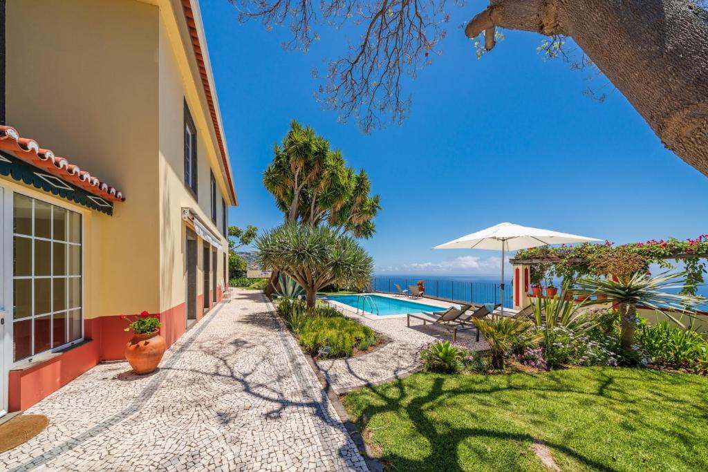 a villa with a pool and a view at OurMadeira - Quinta D'Alegria, character in Funchal