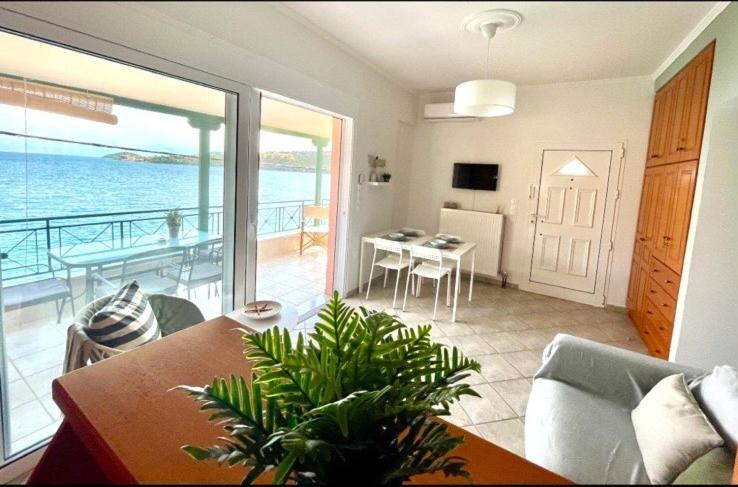 a living room with a view of the ocean at Seaside Apartment in Glyfada-Trizonia in Glyfada Fokidas