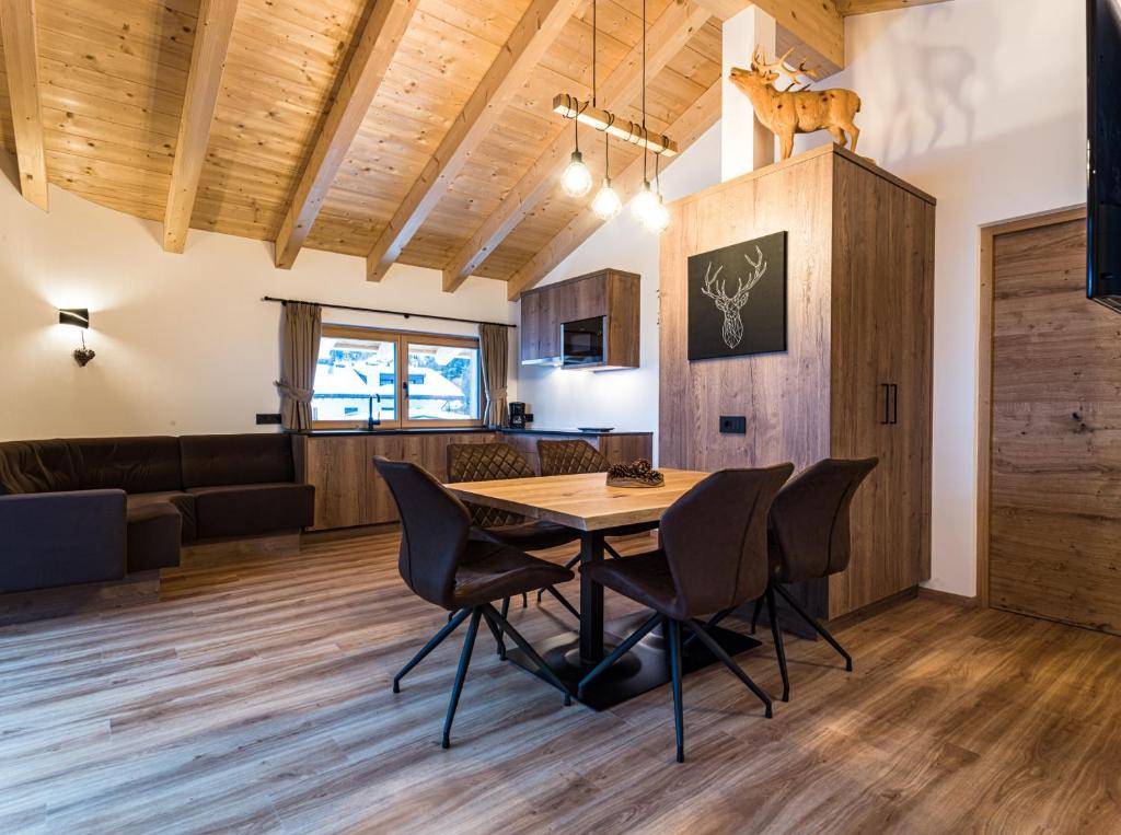 a dining room and kitchen with a table and chairs at Apartments Piciulei in Selva di Val Gardena