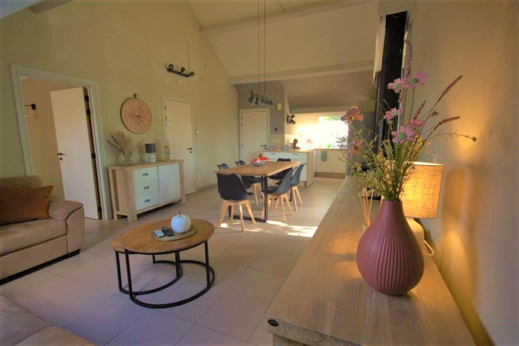 a living room with a vase on a table at stay at durbuy in Durbuy