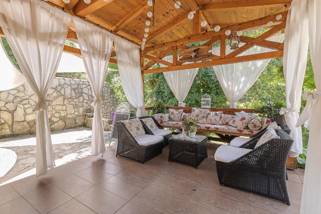 a covered patio with a couch and chairs at Holiday Home Fairytale - Happy Rentals in Jastrebarsko