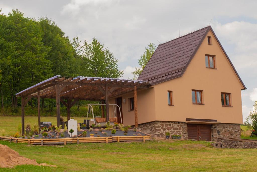 a large house with a wooden roof at Chata Na Vyhlídce in Železnice