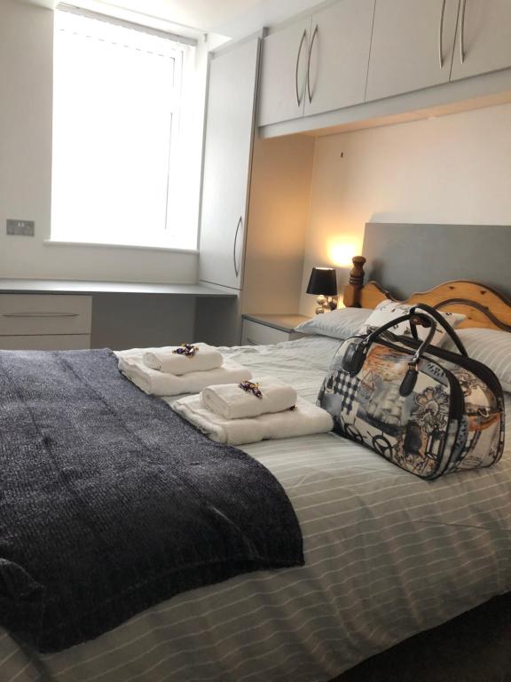 a bedroom with two beds with towels on them at Sweet Caroline at Longton. Great location for Stoke on Trent, The Potteries and Alton Towers. in Longton