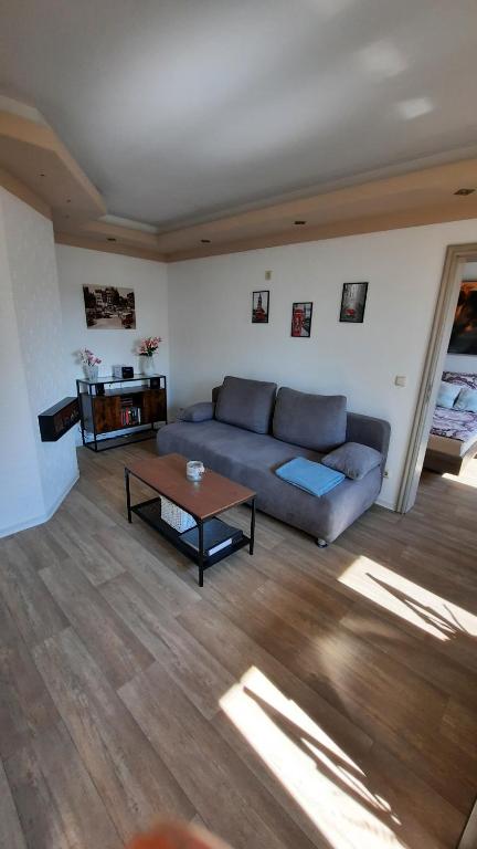 a living room with a couch and a coffee table at Ferienwohnung Schneeberg in Papendorf