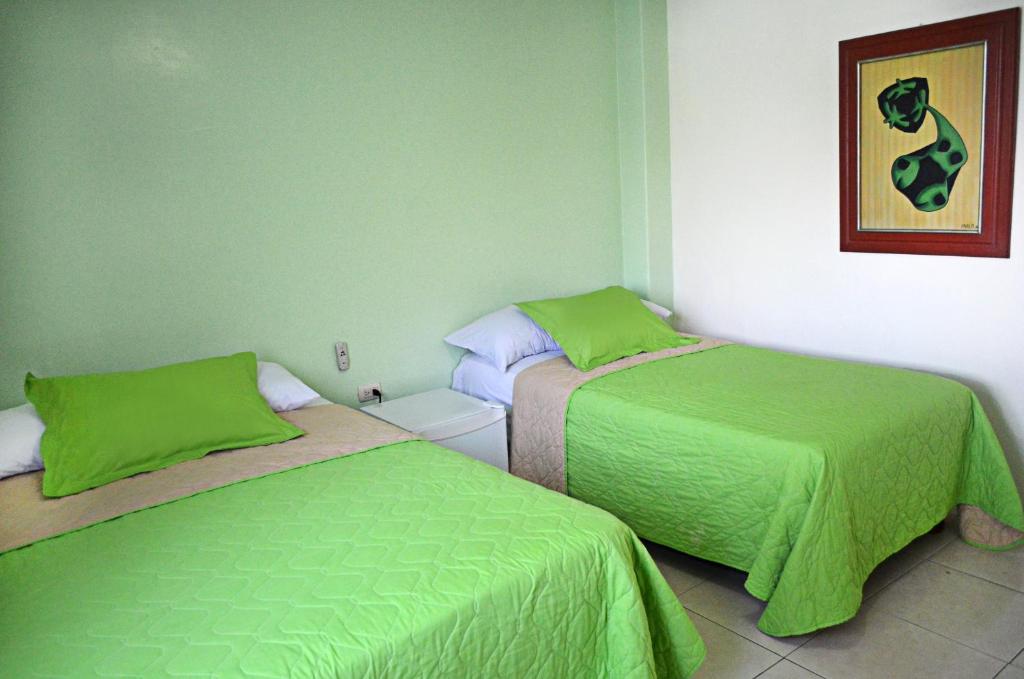 Postel nebo postele na pokoji v ubytování North Star Hostal Guayaquil