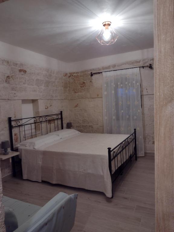 a bedroom with a large bed in a room at La casa di pietra in Monopoli