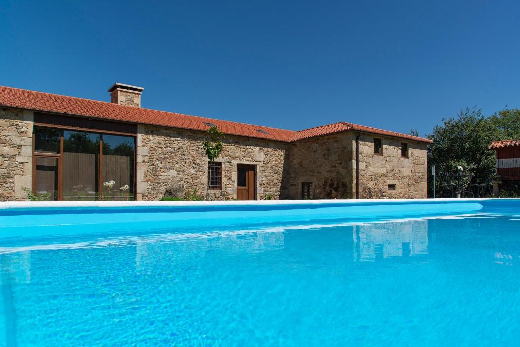 a large blue swimming pool in front of a house at CASA DO LEAL SILVER WAY in Silleda