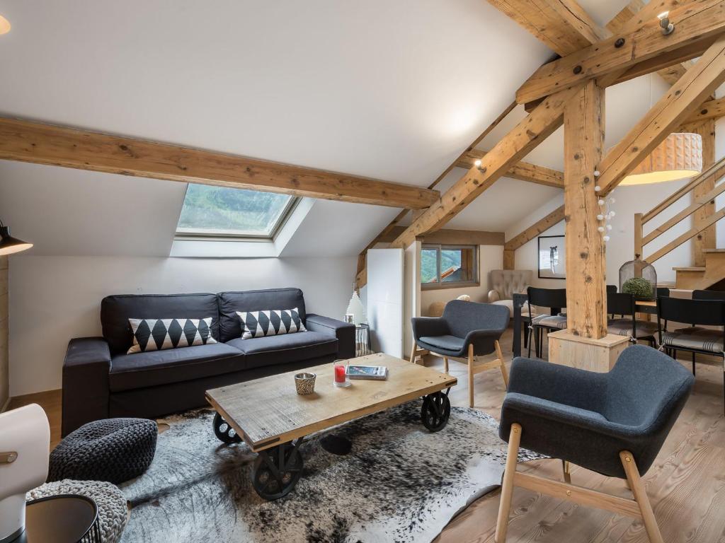 a living room with a couch and a table at Superbe duplex central à Méribel pour 8 pers, proche pistes - FR-1-565-16 in Les Allues