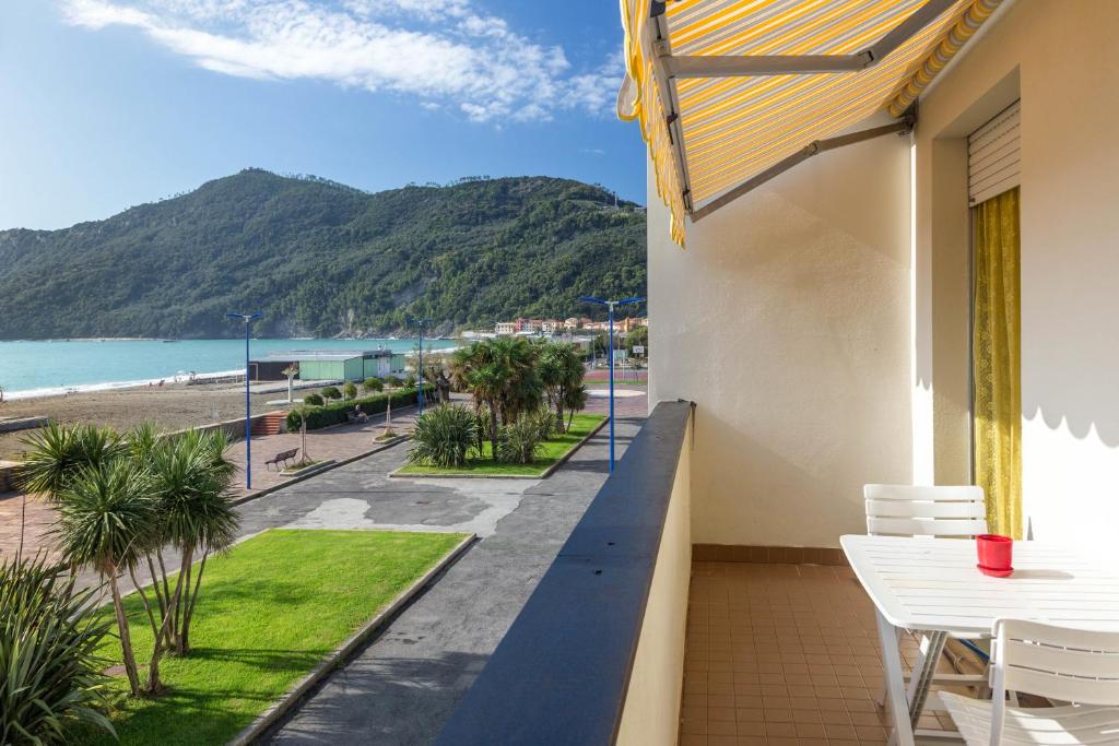 a balcony with a view of the beach at Riva al Mare Flat in Sestri Levante