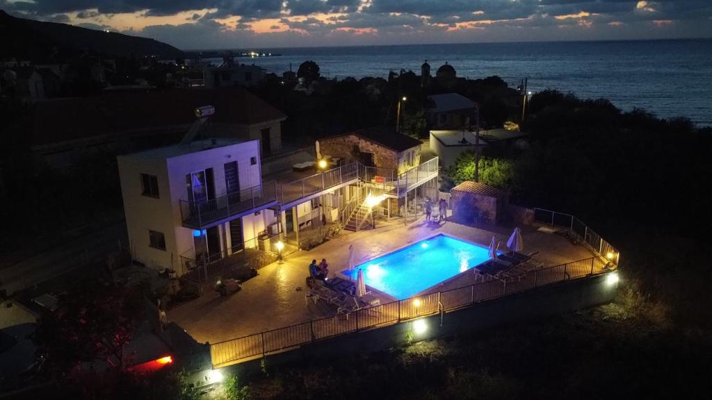 an overhead view of a house with a swimming pool at night at Holiday Apartments,Polynikis Sea-Cret, Pachyammos in Pachyammos