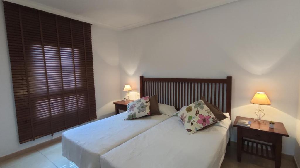 a bedroom with a white bed with two pillows at Pisos El Puerto in Santa Cruz de la Palma
