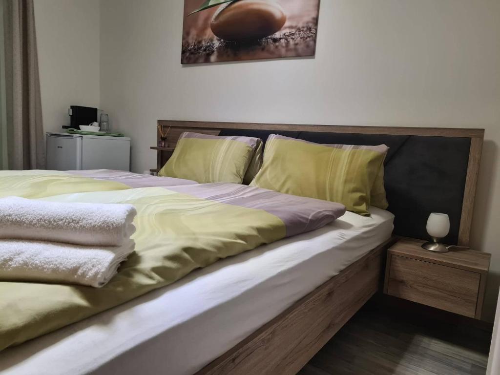 a bedroom with a large bed with yellow sheets at Orchidea2 in Finkenstein