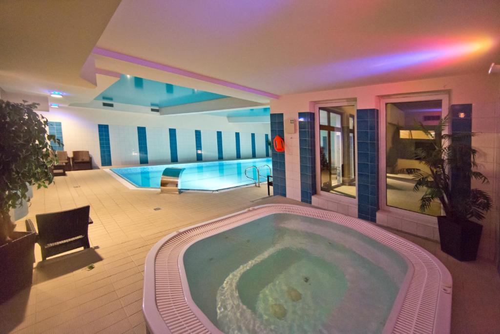 a swimming pool with a jacuzzi tub in a house at Hotel Kameralny in Kielce