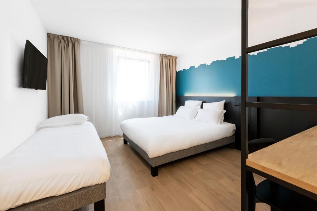 Postel nebo postele na pokoji v ubytování B&B HOTEL Nyon