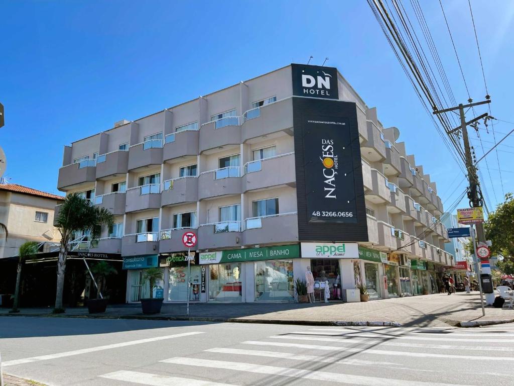 a building with a sign on the side of a street at Das Nações Hotel in Florianópolis