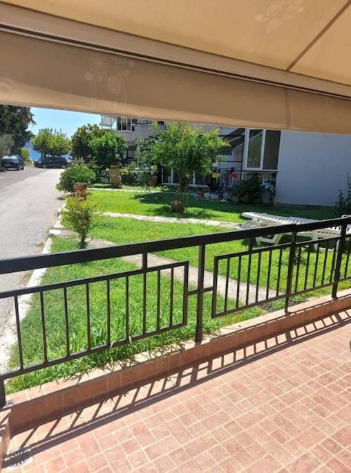 A garden outside Nia's apartment by the sea