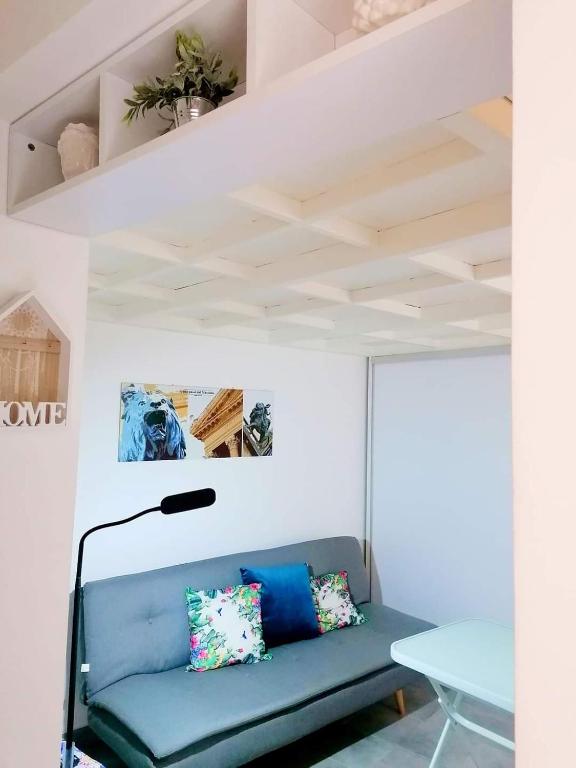 a blue couch in a room with a ceiling at Historic Centre - Apartment Near Teatro Massimo in Palermo