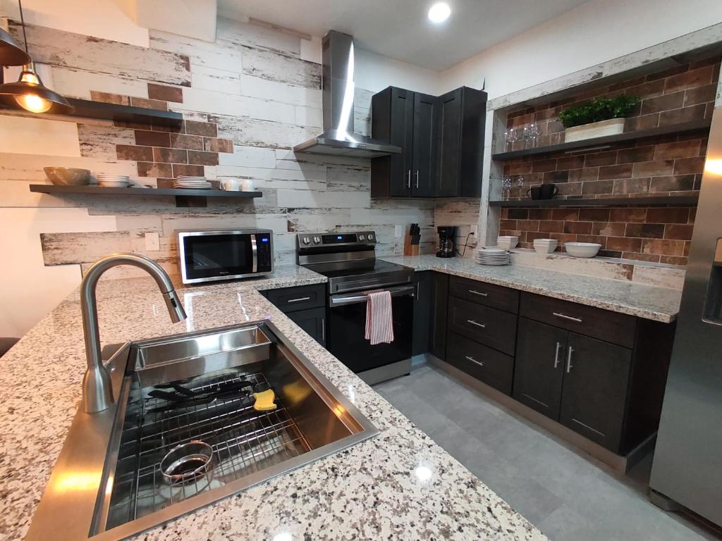 a kitchen with a sink and a counter top at New house with comfortable king beds in Medford