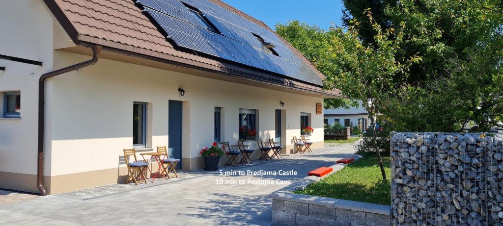 a building with a group of tables and chairs at Nona BB in Postojna