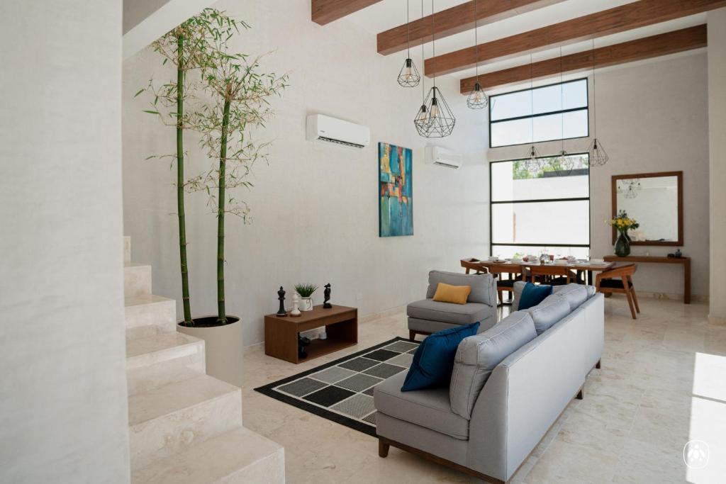 a living room with two couches and a table at Villa Casa Agua by Sunest in Akumal