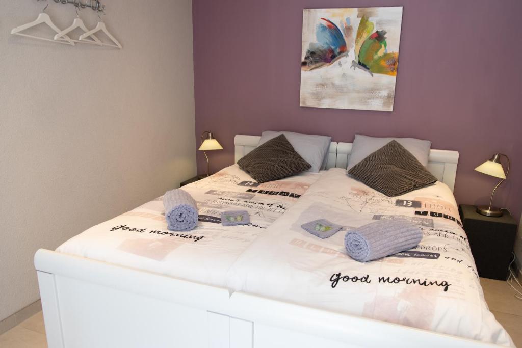 a bedroom with a white bed with towels on it at Studio Excellent 21 in Soesterberg