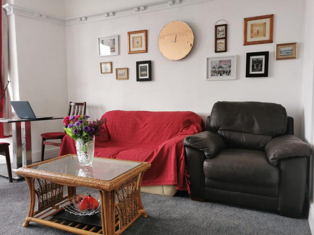 a living room with a couch and a table at Victoria's Apartment - 3 Large Bedroom in Blackpool