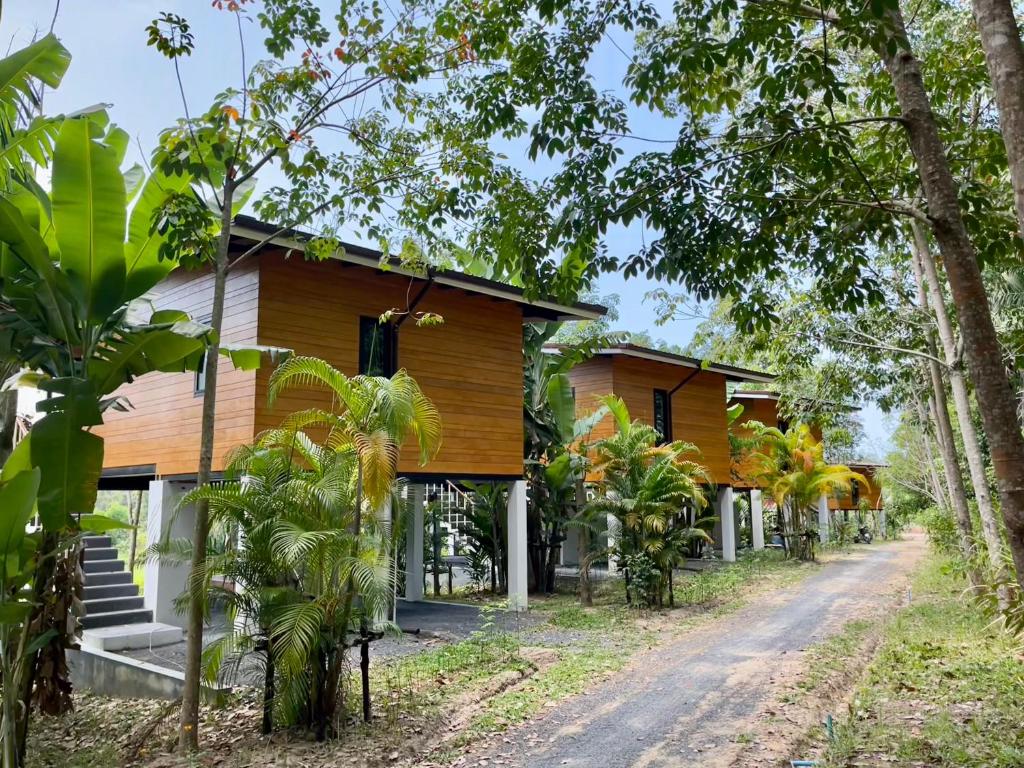 a row of houses on a dirt road at Kunna House in Ko Yao Noi