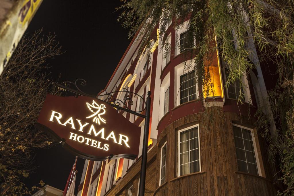 a hotel sign in front of a building at night at Raymar Hotels Ankara in Ankara