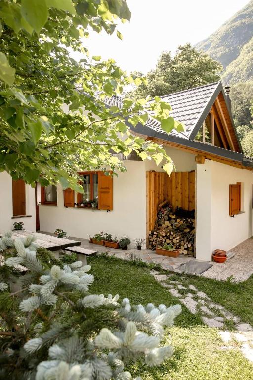 a house with a fire place in the backyard at Apartma Mlekuž in Bovec