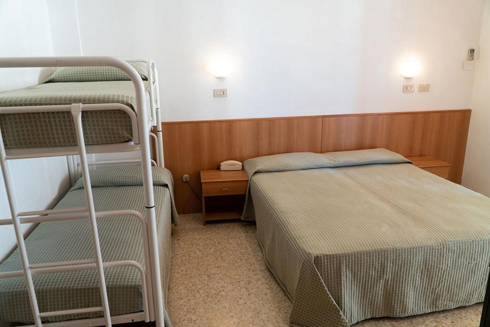Postel nebo postele na pokoji v ubytování Hotel Cinzia
