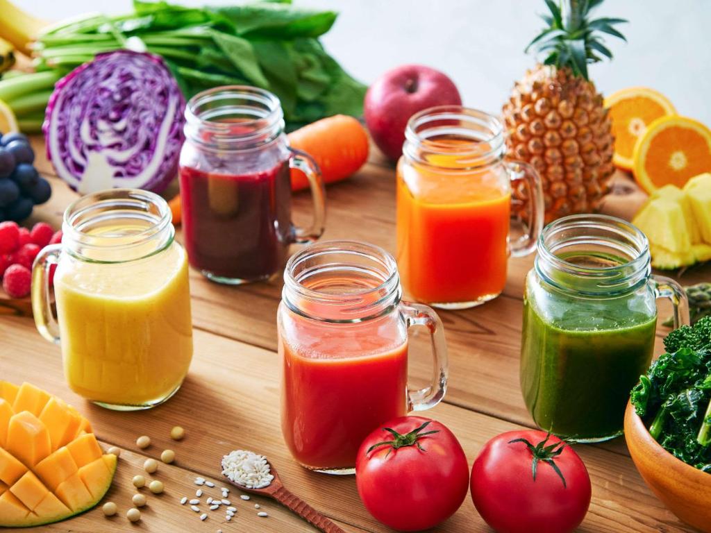 a wooden table with jars of different types of fruits and vegetables at Comfort Hotel Tokyo Kanda in Tokyo