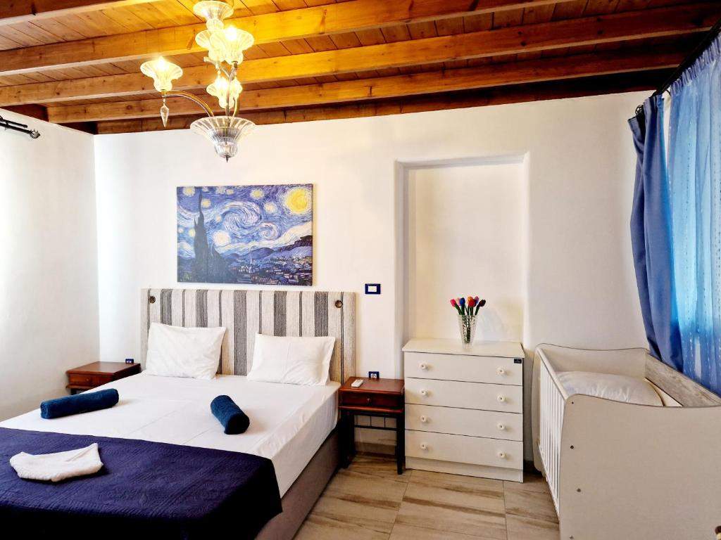 a bedroom with a bed and a chair at Lianas Garden House in Rhodes Town