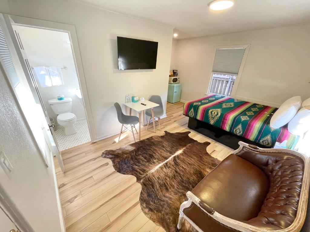 a bedroom with a dog laying on the floor at Frederick Motel in Fredericksburg