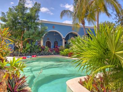 a large swimming pool in front of a house at Casa 411 in Mérida