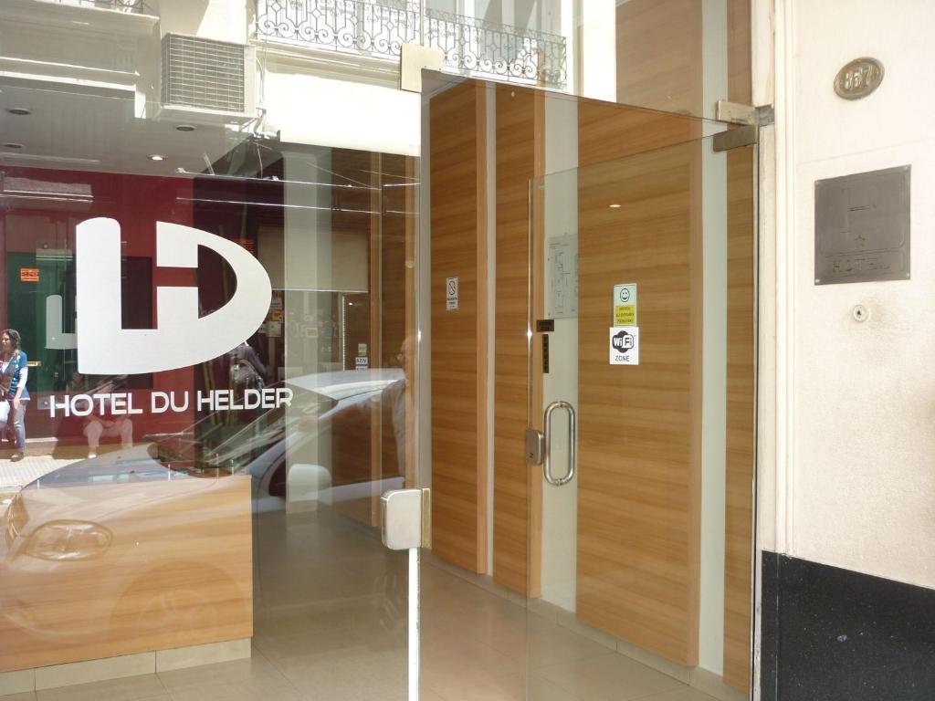 a glass door in a building with a hotel dollar sign at Hotel Du Helder in Buenos Aires