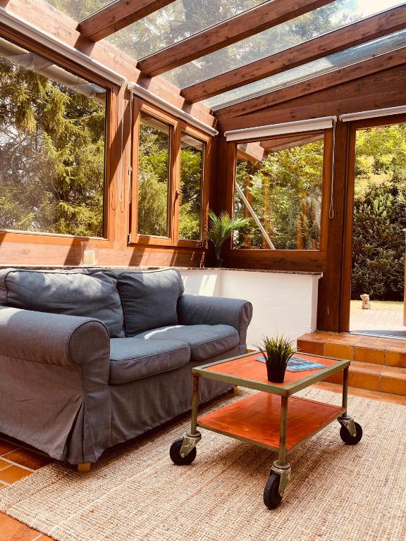 a living room with a couch and a table at Ferienwohnung mit Sauna am Wald - Eifel in Kommern