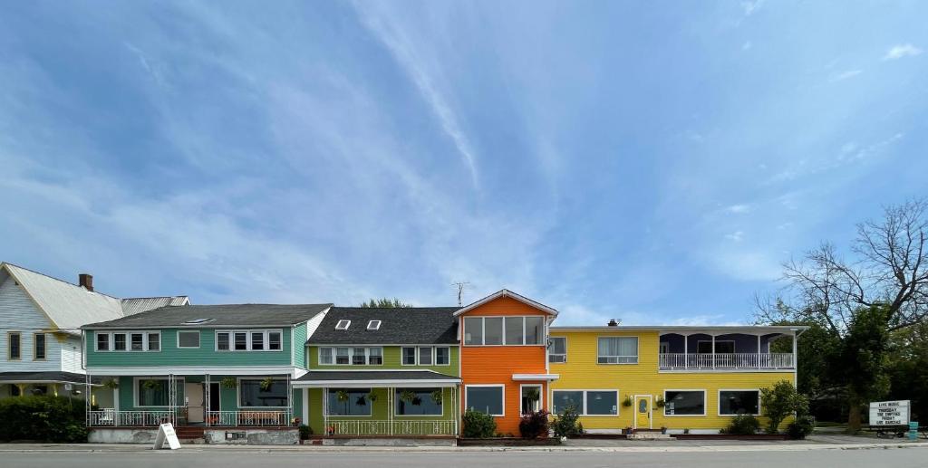 a row of colorful houses on the side of a street at Hotel Wolfe Island in Marysville