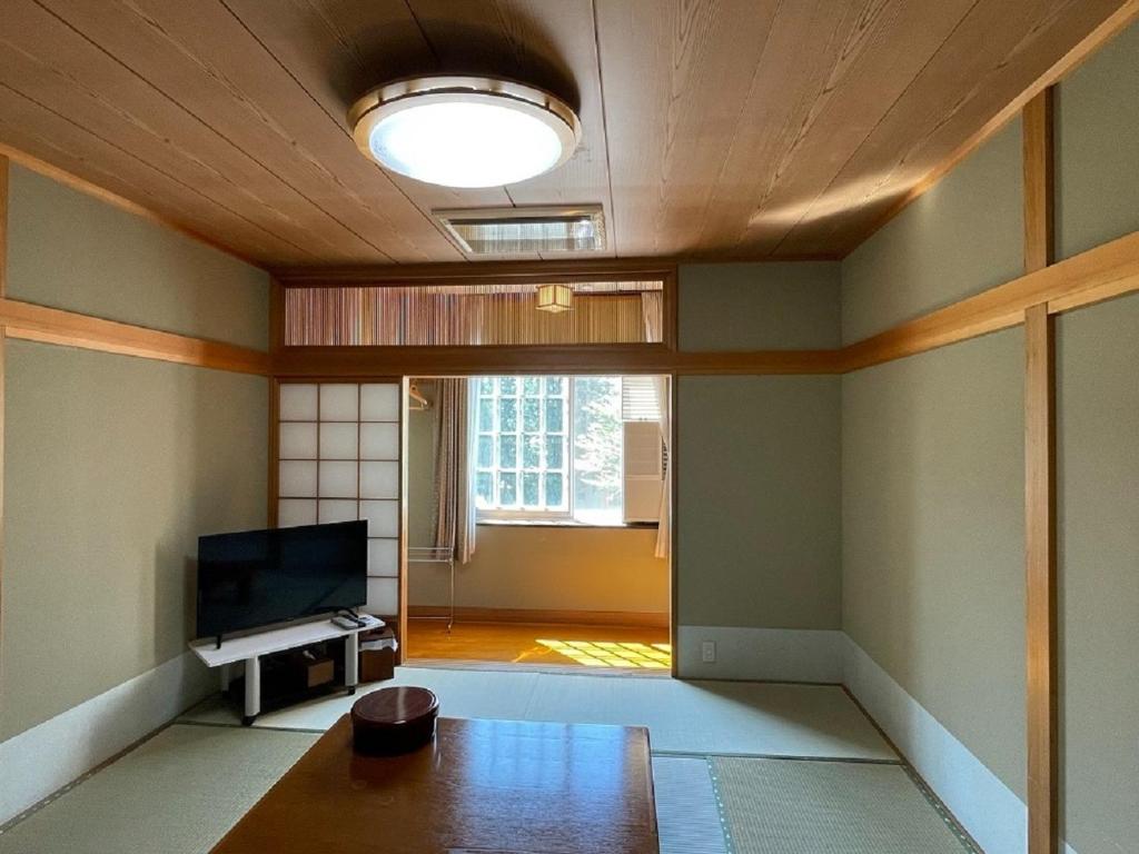 a living room with a table and a television at Koguriyama Sanso - Vacation STAY 16071v in Minami Uonuma