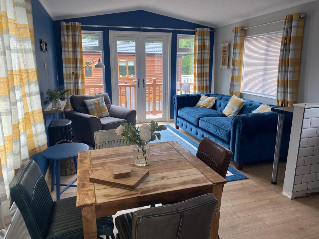 River View Lodge في Felton: غرفة معيشة مع أريكة زرقاء وطاولة