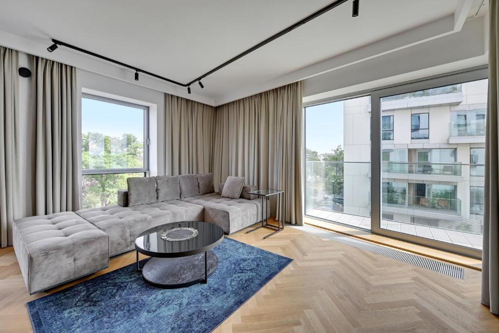 a living room with a couch and a table at Wave Apartments - Yacht Park 2 in Gdynia