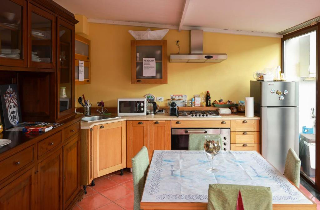 a kitchen with a table and a refrigerator at San Berillo house in Catania