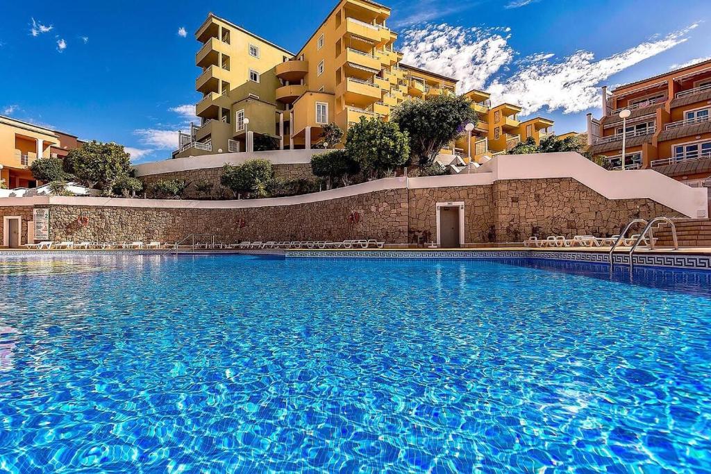 a large swimming pool in front of some buildings at INN Orlando in Adeje