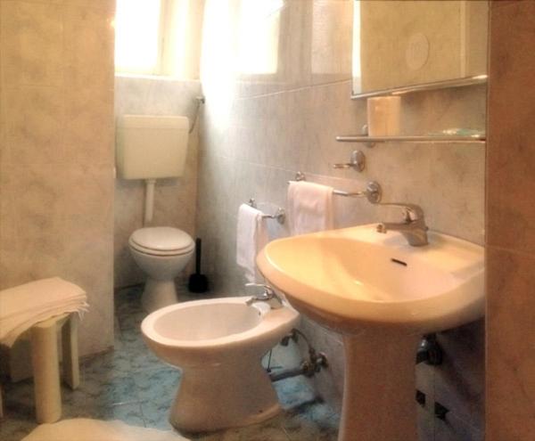 a bathroom with a sink and a toilet at Hotel Umbria in Perugia
