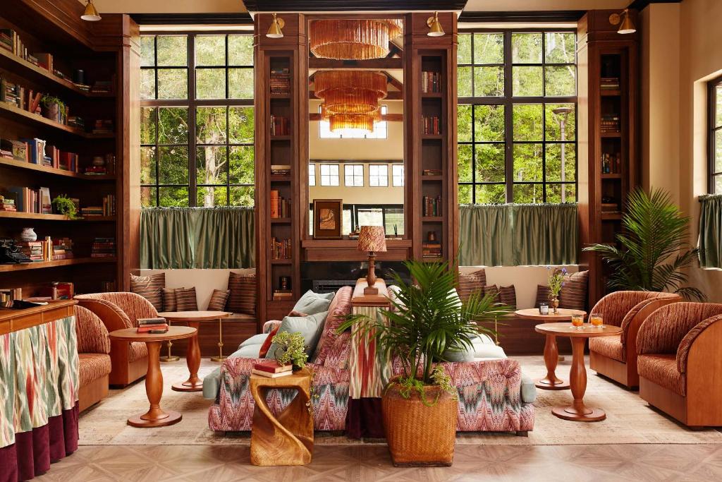 a living room with a couch and tables and windows at Life House, Berkshires in Lenox