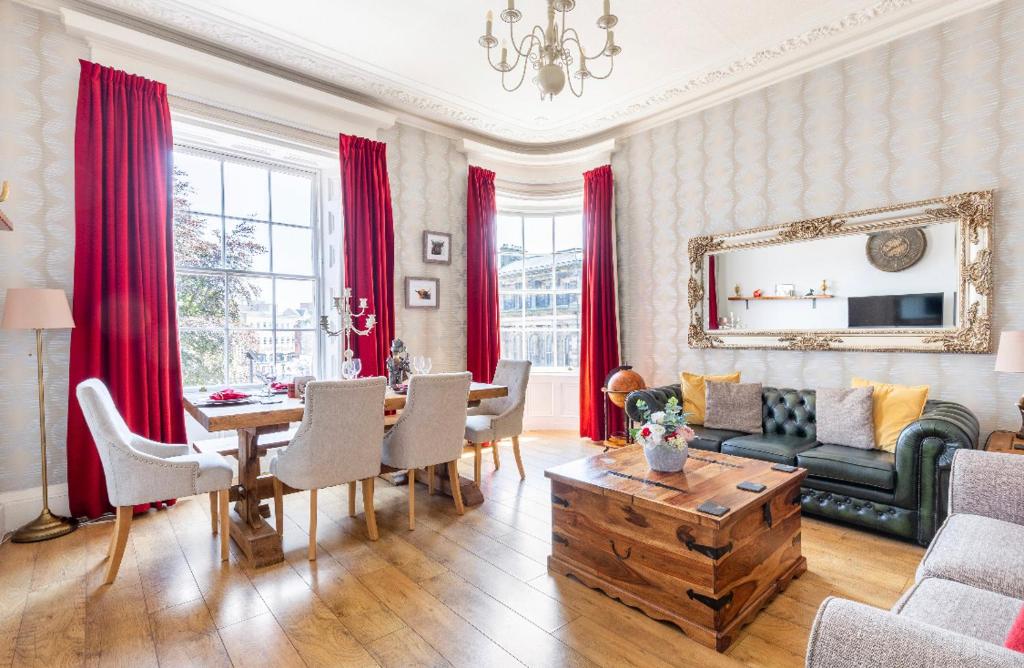 a living room with a couch and a table at Heart of Ayr: elegant townhouse in central Ayr in Ayr
