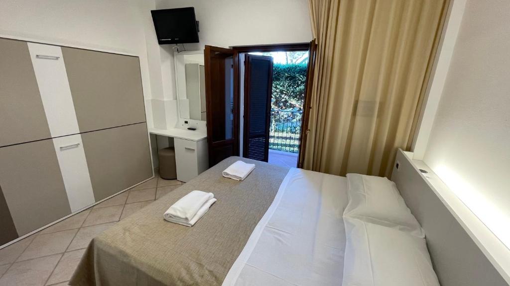 Postel nebo postele na pokoji v ubytování Hotel Boschetto