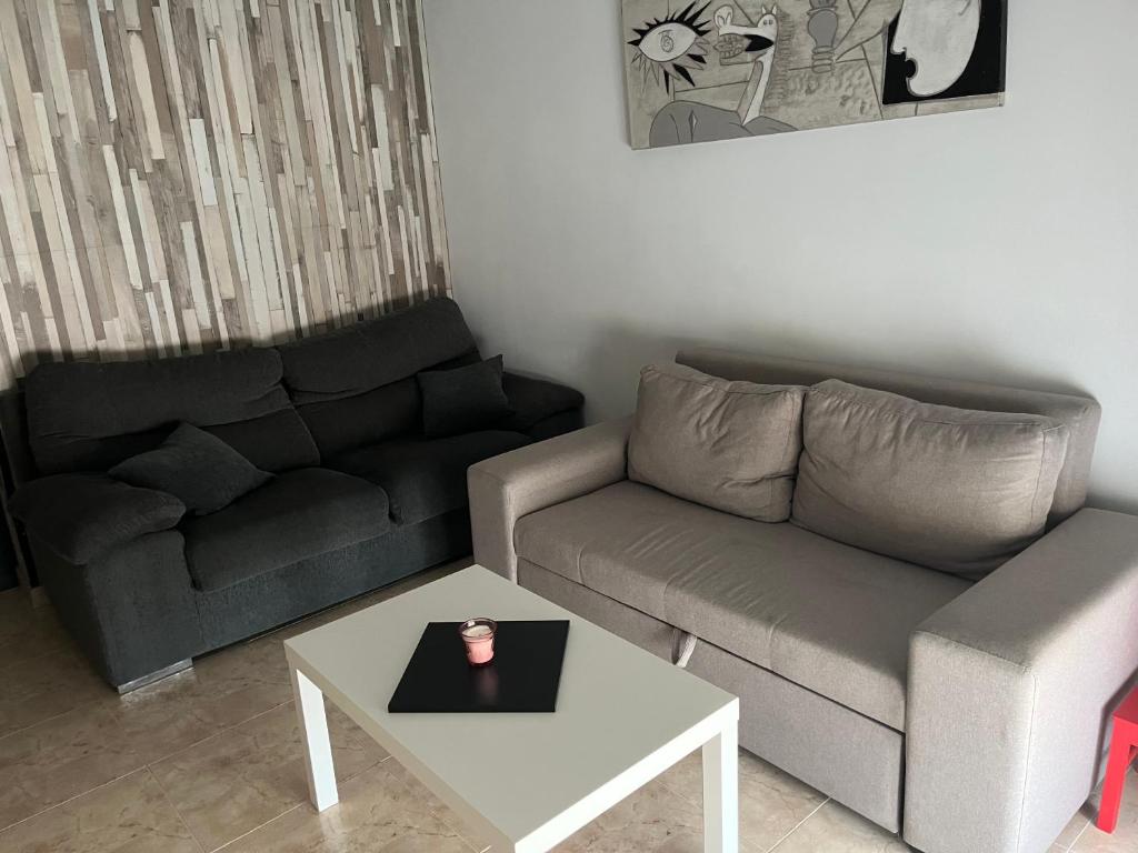 a living room with a couch and a coffee table at APARTAMENTO HERRERIA in Caldas de Reis