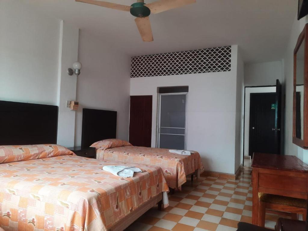 Postel nebo postele na pokoji v ubytování HOTEL ACUARIO CATEMACO