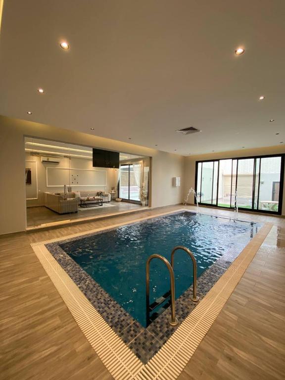 a large swimming pool in a large building at شاليهات ضوء in Taif