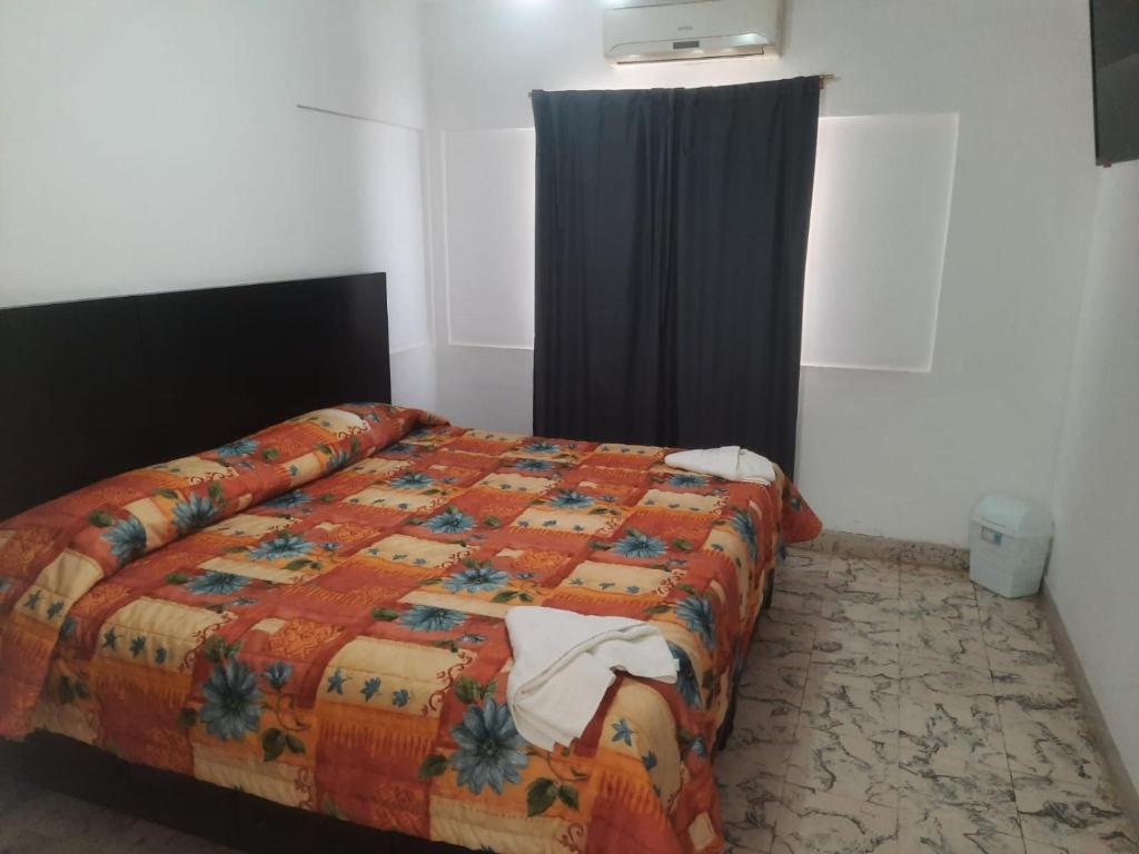 Postel nebo postele na pokoji v ubytování HOTEL ACUARIO CATEMACO